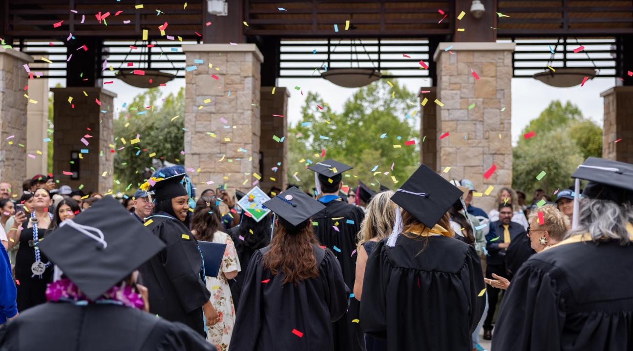 Graduates throwing Confetti