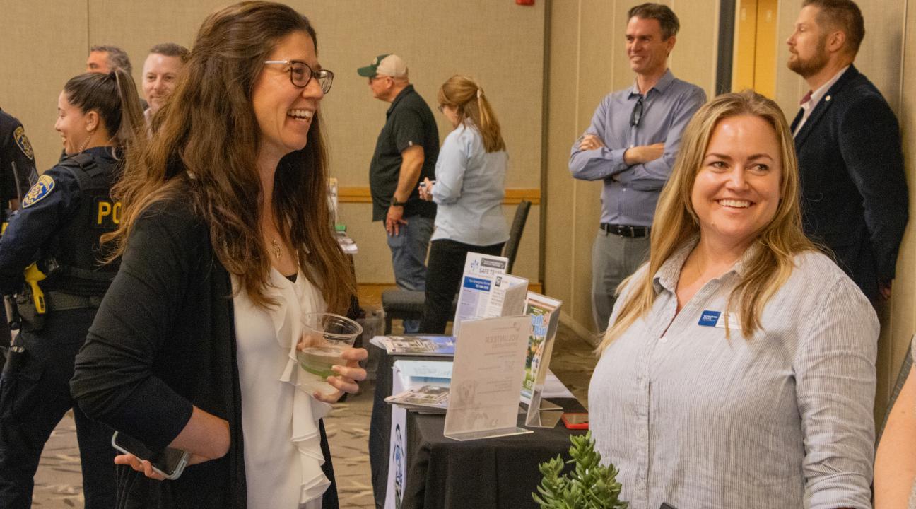 Erin Rock and Kindra Kautz talking at table