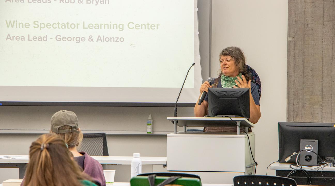 Christa Irwin speaking at lecturn