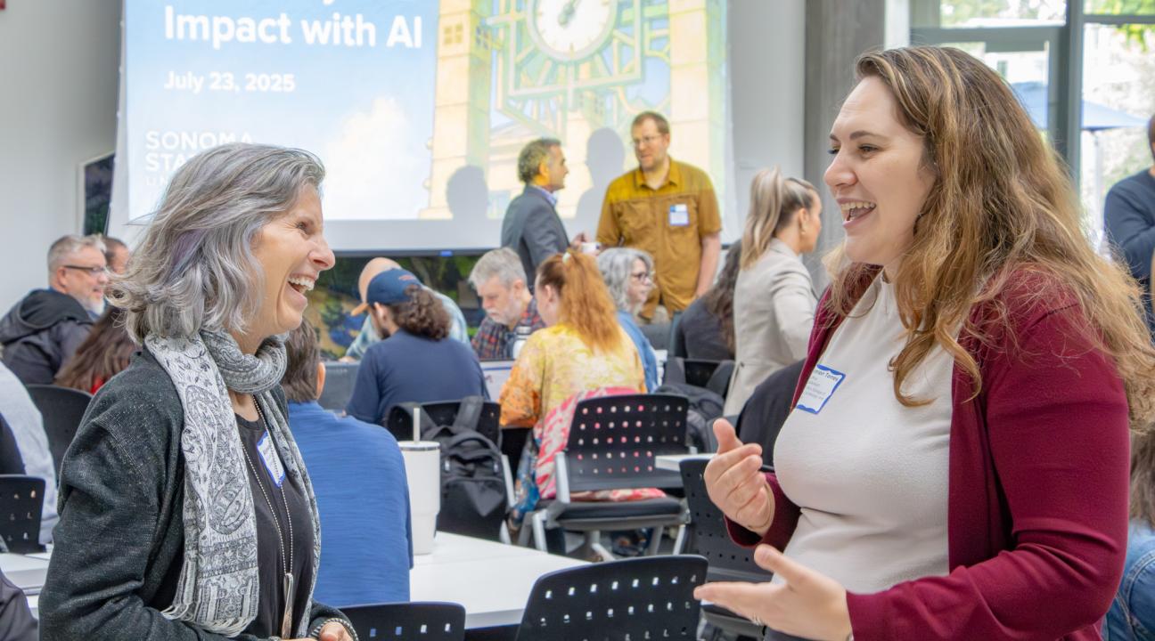 Colleagues chatting and laughing at Summer AI Day