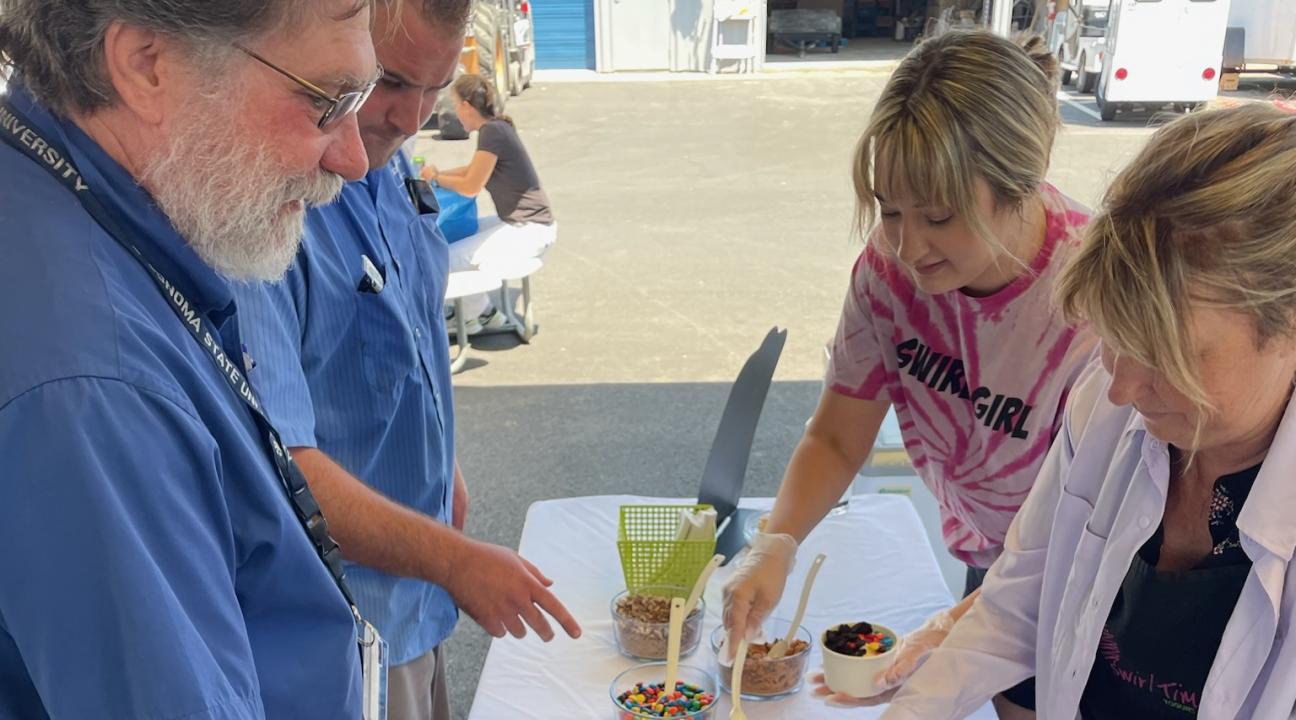 group of people scooping toppings into bowls