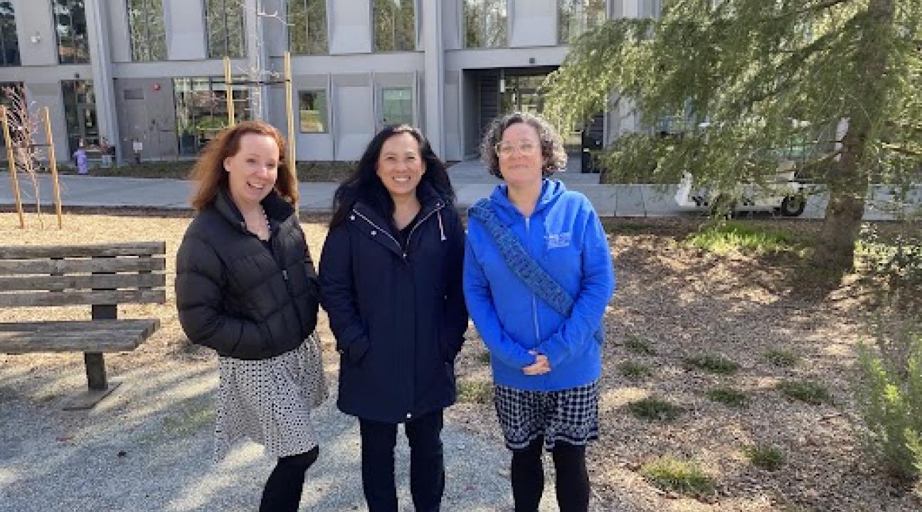 photo of three people outside Stevenson Hall
