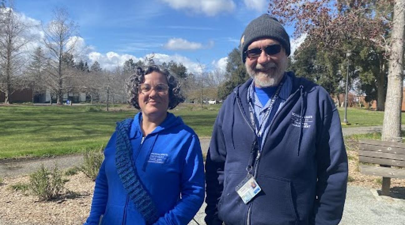photo of two people both wearing blue hooded sweatshirts
