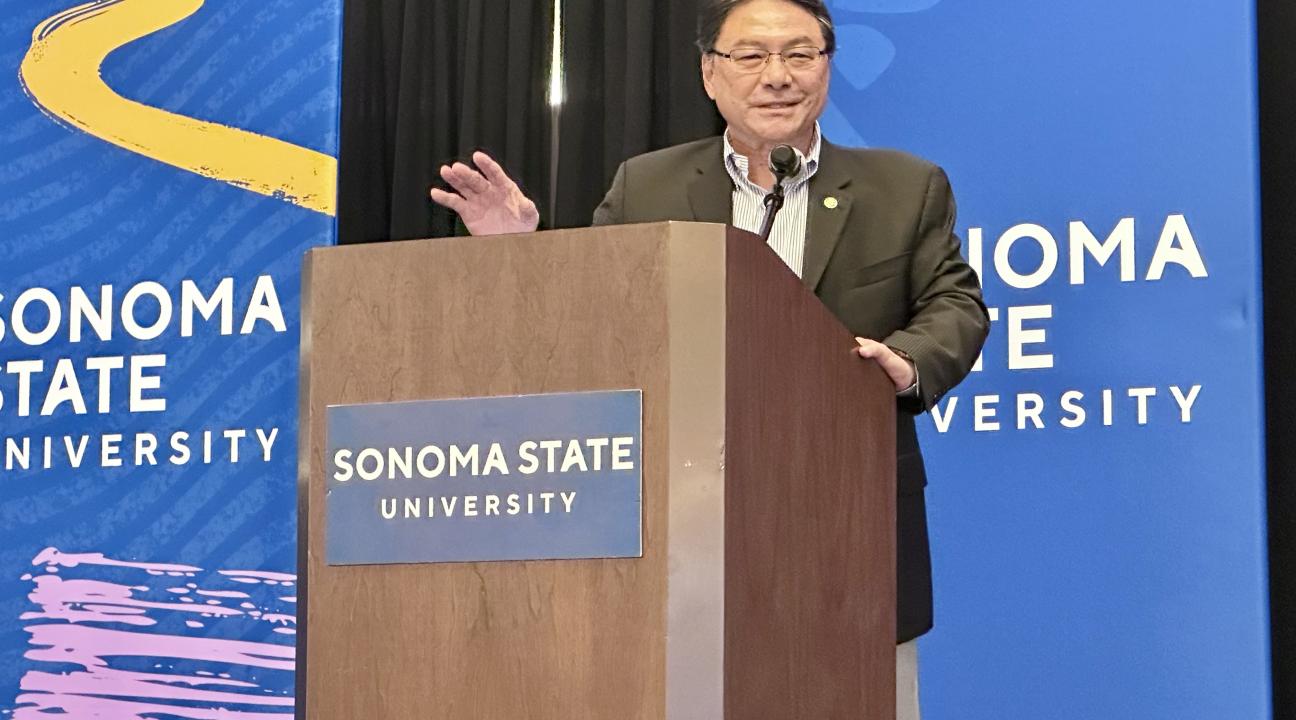 Dr. Lee speaking at the milestone event