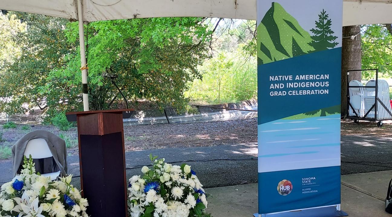 photo of banner, podium and flowers
