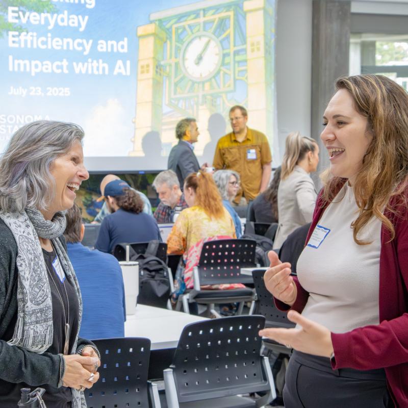 Colleagues chatting and laughing at Summer AI Day