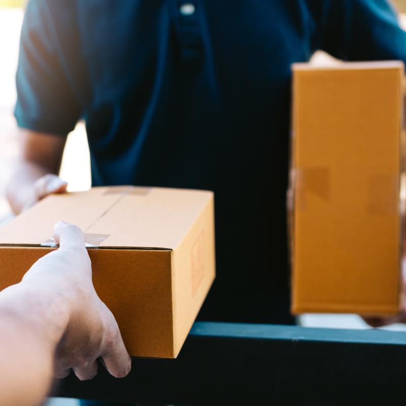 Package being handed from one person to another