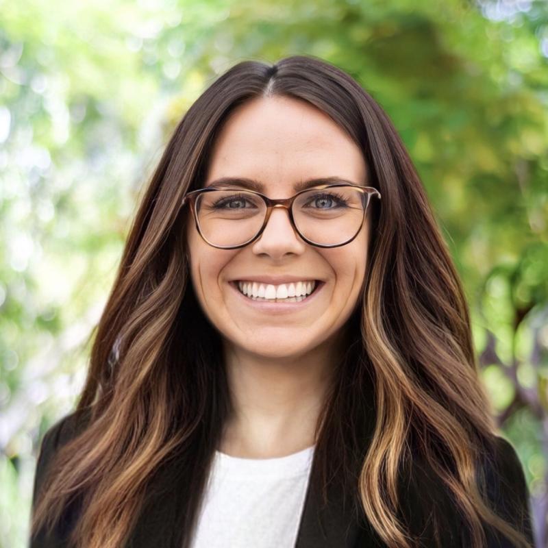 photo of  person with past shoulder length hair, glasses and smile