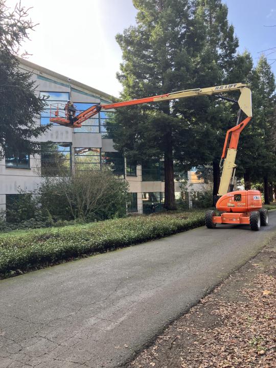 Movers team on boomlift cleaning Schulz windows