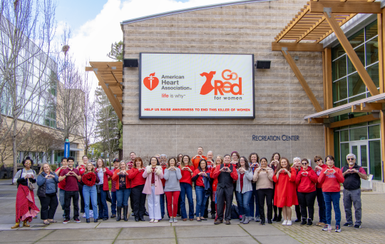 Members of SSU dressed in red and displaying heart hands