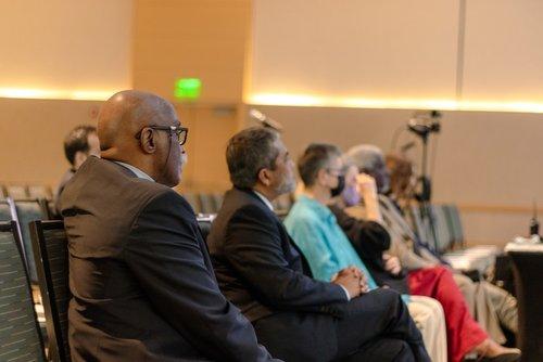 Attendees looking at speaker on stage