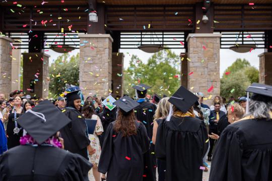 Graduates throwing Confetti