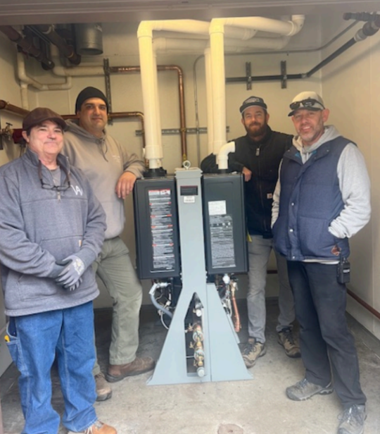 Unit 6 team next to newly installed water heaters