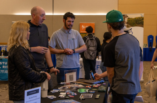 Students engaging with employers at career fair