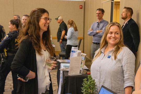 Erin Rock and Kindra Kautz talking at table