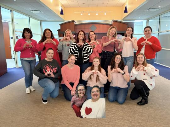 Suite 2050 team dressed in pinks, reds, and hearts