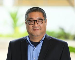 Head shot photo of man with glasses and shortly cropped hair