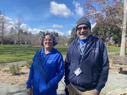 photo of two people both wearing blue hooded sweatshirts