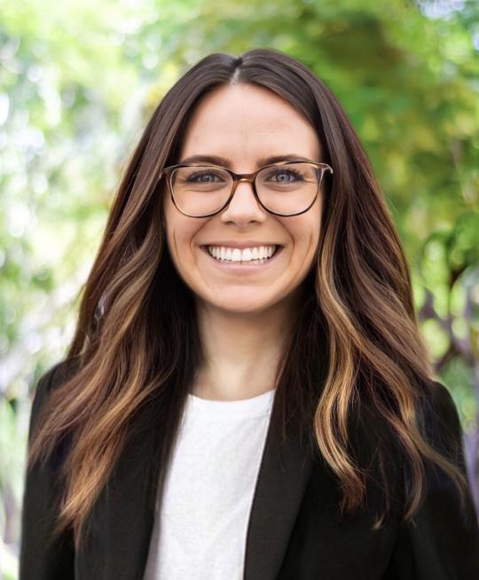 photo of  person with past shoulder length hair, glasses and smile