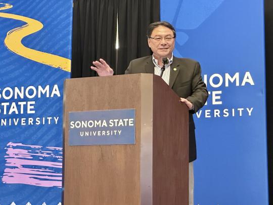 Dr. Lee speaking at the milestone event